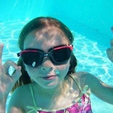 Children splashing and having fun in a swimming pool
